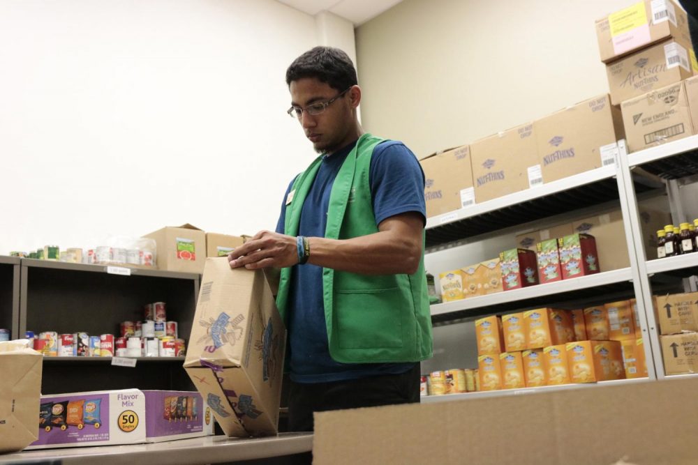 Pictured here is Muhammad Alam, kinesiology major, as he helps unpack food at American River College food pantry on March 13, 2020, just days before the campus shutdown. Since then, the Beaver Food Pantry has continued to work remotely. (Photo by Emily Mello)