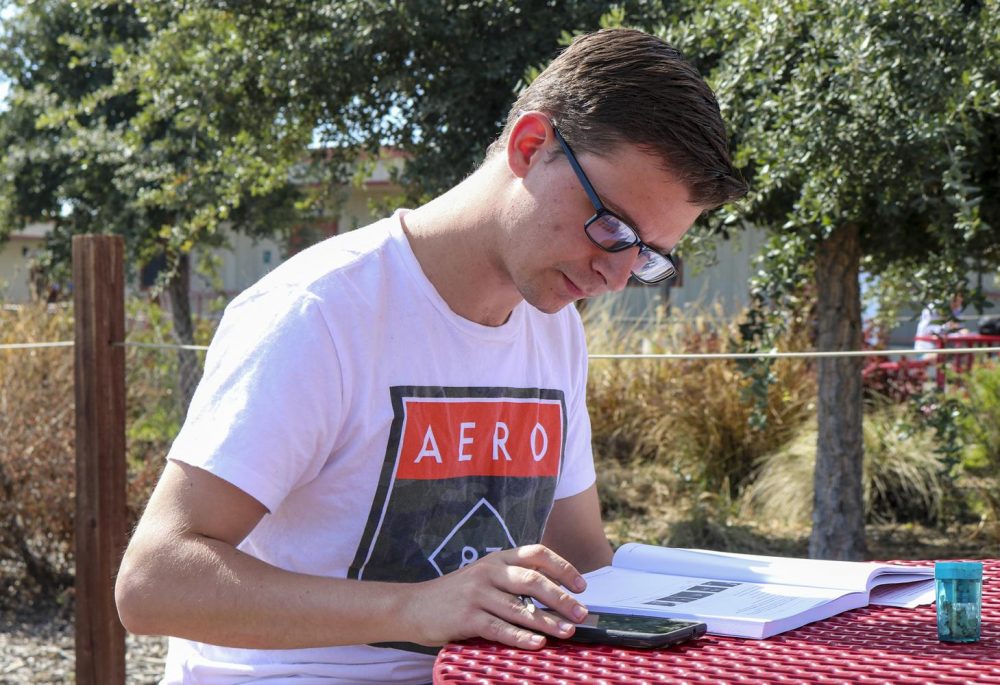 Physics major,  Jonathan Macdonald sits outside at a table in the Portable Village, studying on March 9, 2020 at American River College. (Photo by Brandon Zamora)