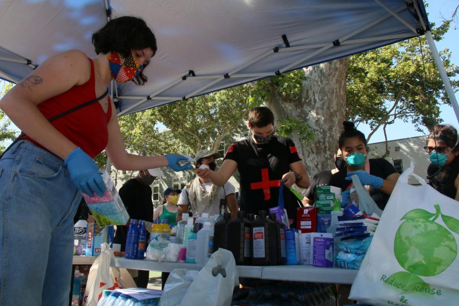 The Sacramento LGBT Community Center and the Gender Health Center stationed themselves in the Center’s parking lot on 20th and J Street in downtown Sacramento to provide medical supplies for protesters, on June 2, 2020. Volunteers assembled care kits that contained medical supplies, snacks, and water to be distributed for the demonstrators while they marched against police brutality. (Photo by Emily Mello)  

