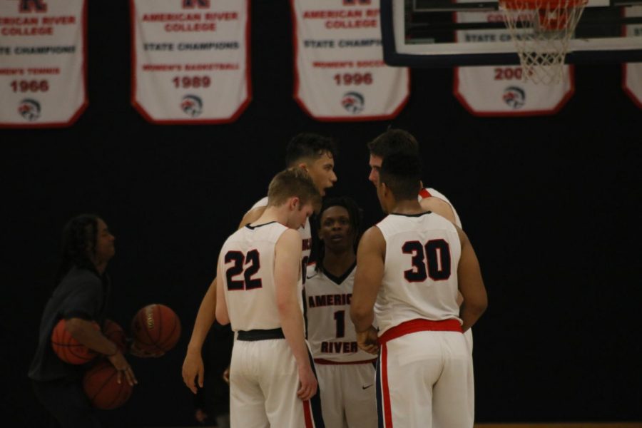 Members of the American River College men’s basketball team huddle up during the game against San Joaquin Delta College on February 11, 2020. The team is now working out on their own, after practices and games have been canceled due to the coronavirus pandemic. (Photo by Heather Amberson)