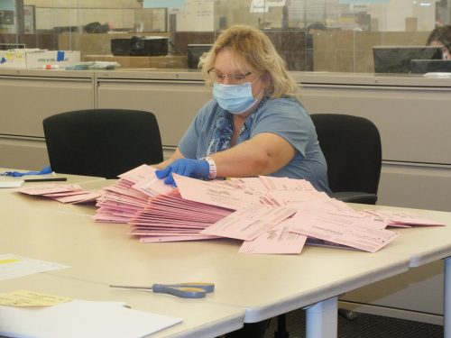 A ballot worker in Sacramento, California goes through hundreds of ballots received by the County Registers office on , Election Day, Tuesday Nov. 3, 2020. (Photo by Irvis Orozco)