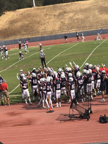 The American River College football team cheers on its players, though the team sustained a 16-30 loss versus Laney college on Oct. 2, 2021. (Photo by Cynsere Kelly) 
