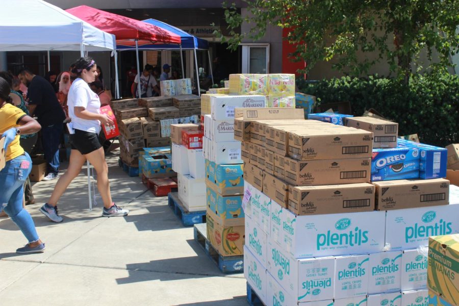 The American River Food Pantry, pictured here Aug. 27, 2019, stacks food, waiting to be handed out to students and teachers who have come. Beaver Cares is bringing back monthly food distributions to students starting on Feb. 8, 2022, as well as housing, clothes, and other basic essential amenities.(File Photo)