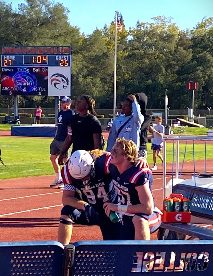 In the last minute, teammates Kai Wallin and Michael Sullivan kneel in solidarity hoping for the win against Butte College, on Oct. 22. (Photo by Carla Montaruli)