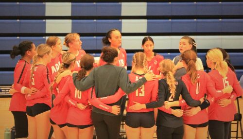 Carson Lowden, the American River College womens volleyball team head coach, gives the team a pep-talk on the sidelines before going into the third set. (Photo by Jaqueline Ruvalcaba)