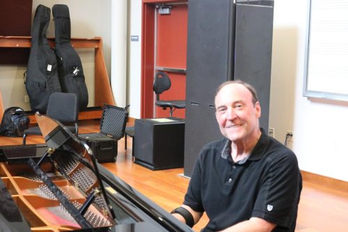 Art Lapierre sits at his piano after the ensembles rehearsal May 3. (Photo by Shy Bell)