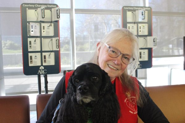 Paula Ackman, a volunteer from Lend A Heart, with therapy dog Cosmo on February 28, 2024 in the Student Center at American River College. (Photo by Chris Johnson)