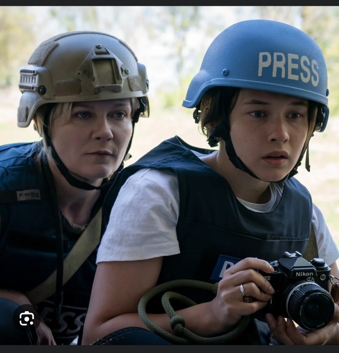 “Civil War” On the right, Jessie, played by Cailee Spaeny and on the left, Lee, played by Kristen Dunst are in the middle of the war trying to get a photo with bullets flying by. (Photo courtesy of A24)