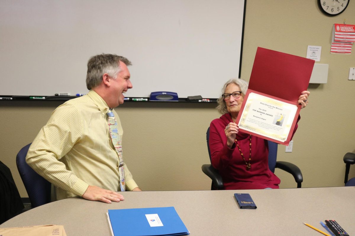 Benjamin Etgen, American River College math teacher and transit advocate, receives the “Top Banana” award from Barbara Stanton with Ridership for the Masses on Nov. 13. The award has been presented to Etgen for his continued work in the field of mass transit advocacy. (Photo by Will Forseth)
