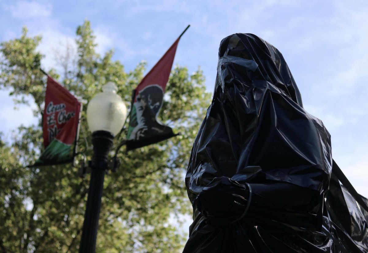 At Cesar Chavez Plaza in the heart of Downtown Sacramento, statues and signs honoring the American labor unionist Cesar Chavez have been wrapped in plastic.

After Dolores Huerta, an American labor leader and feminist activist, spoke out about Chavez molesting and raping women and young girls, Sacramento covered his statue and the park’s sign on March 20, 2026.

The Sacramento City Council denounced Chavez and called to rename the plaza.

(Photo by: Mei Mizutani) 
